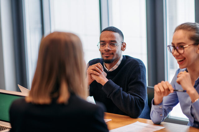 In the vibrant ambiance of a modern startup office, a diverse team of business professionals engage in discussions on various projects and develop new business strategies, epitomizing creativity and innovation in the entrepreneurial landscape